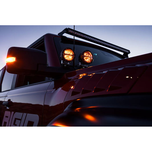 Rigid LED lights mounted on truck roof with amber glow, enhancing off-road visibility and style.