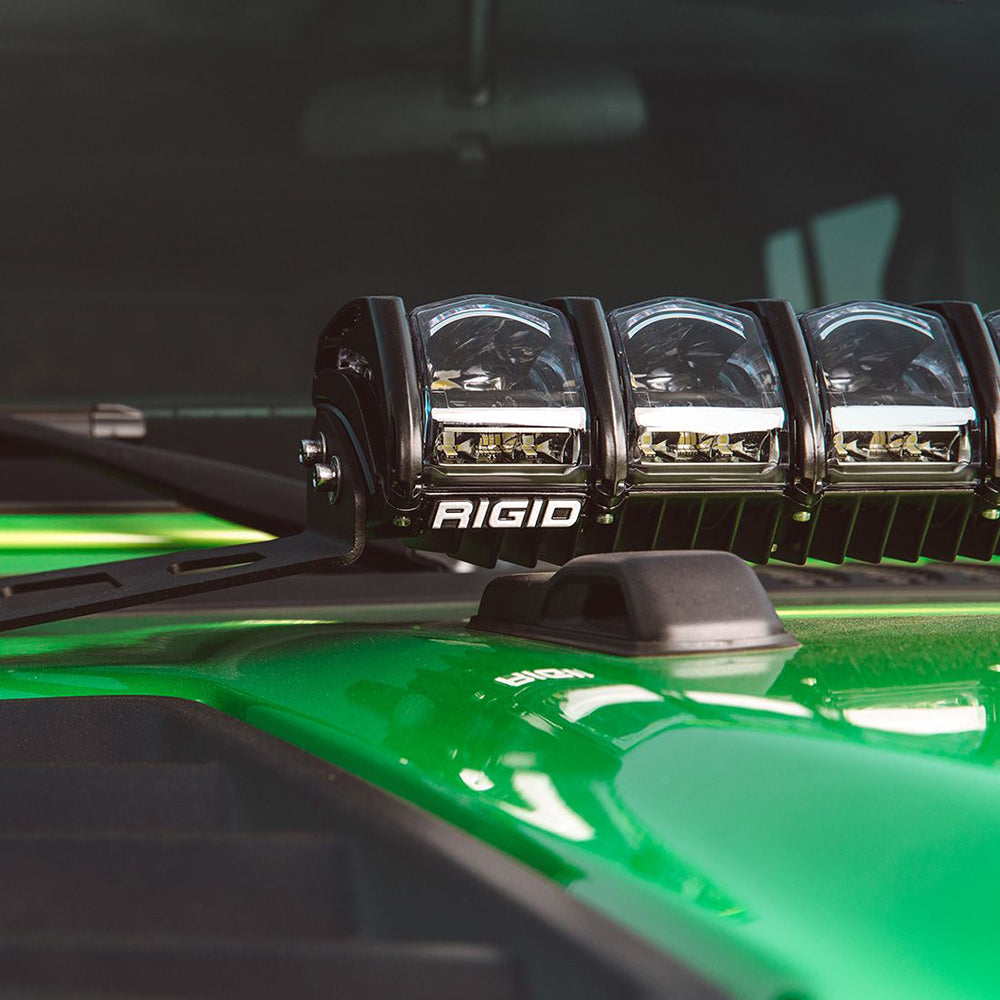 Rigid LED light bar mounted on green off-road vehicle hood for enhanced visibility