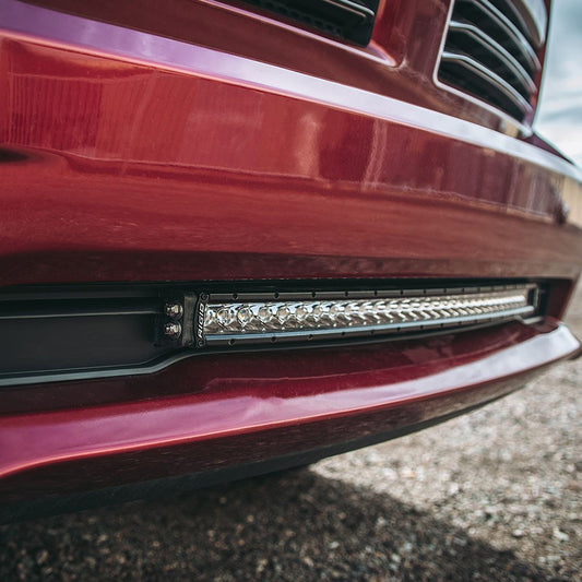 Rigid LED light bar installed on red truck bumper for off-road illumination
