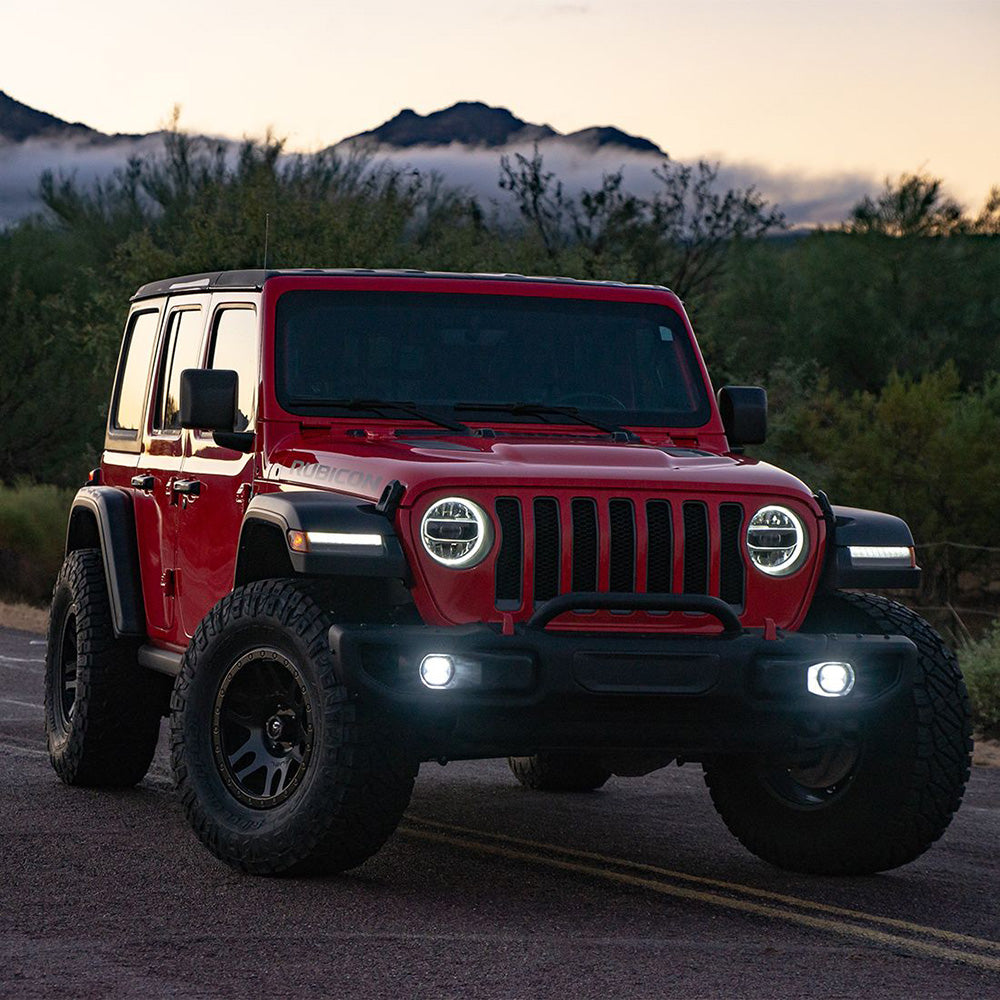 Red Jeep Wrangler Rubicon with LED headlights on desert road at dusk, rugged off-road styling