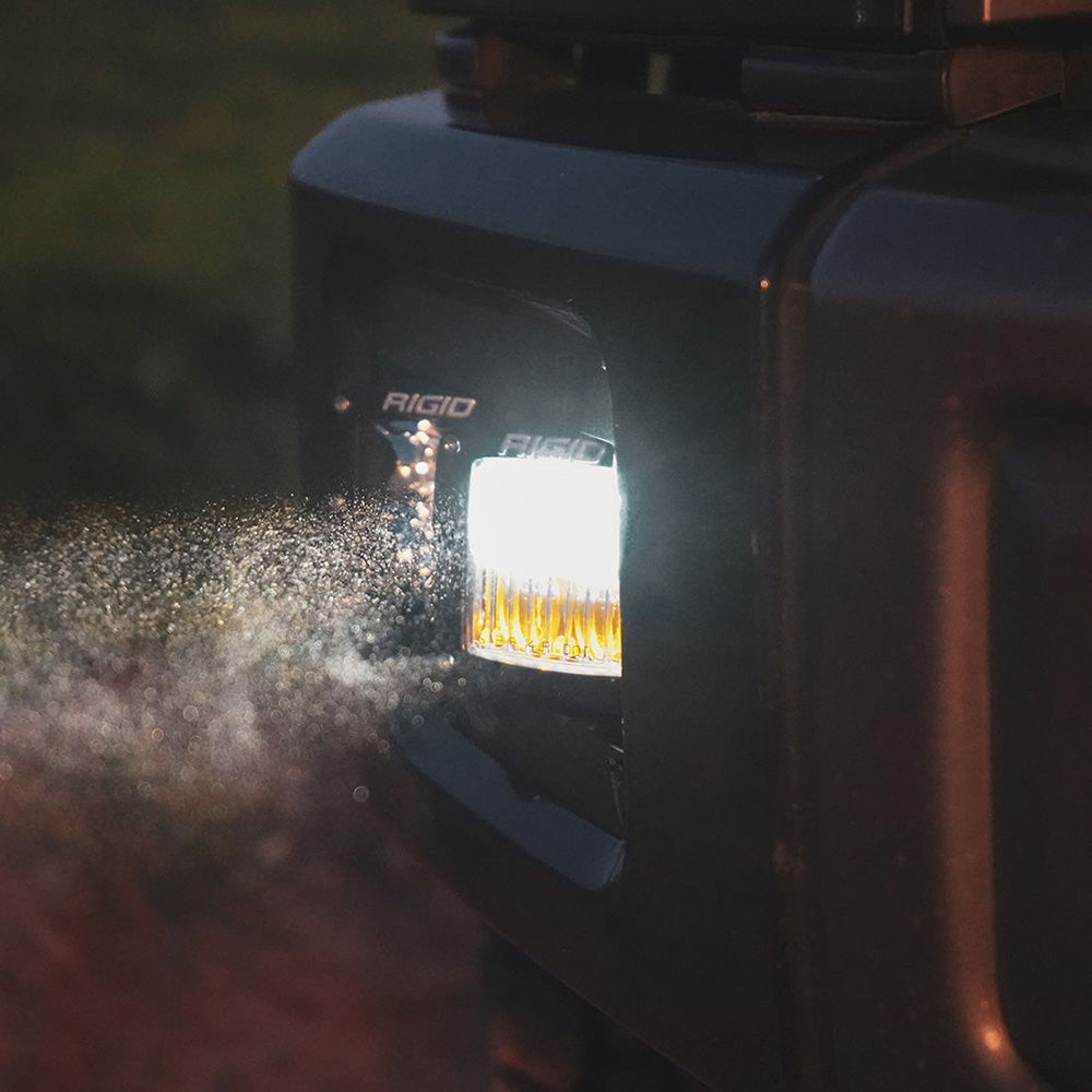 Rigid LED light bar illuminating mist, mounted on rugged vehicle for off-road use