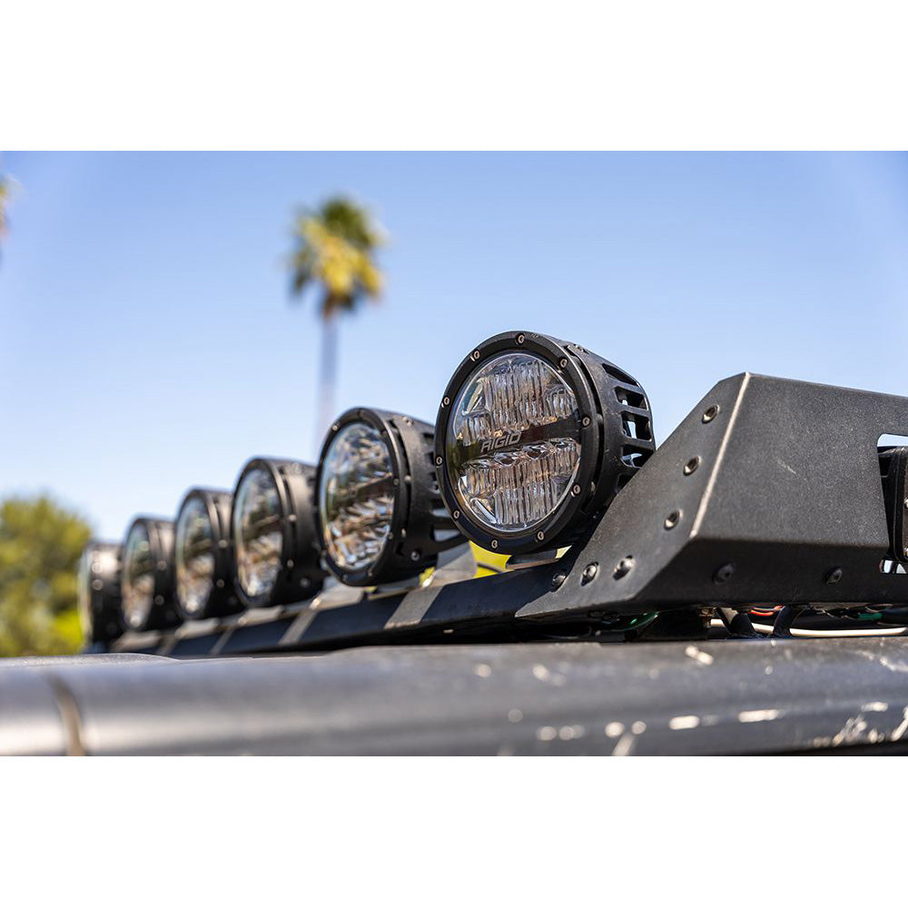 Rigid LED off-road lights mounted on vehicle roof rack under clear sky