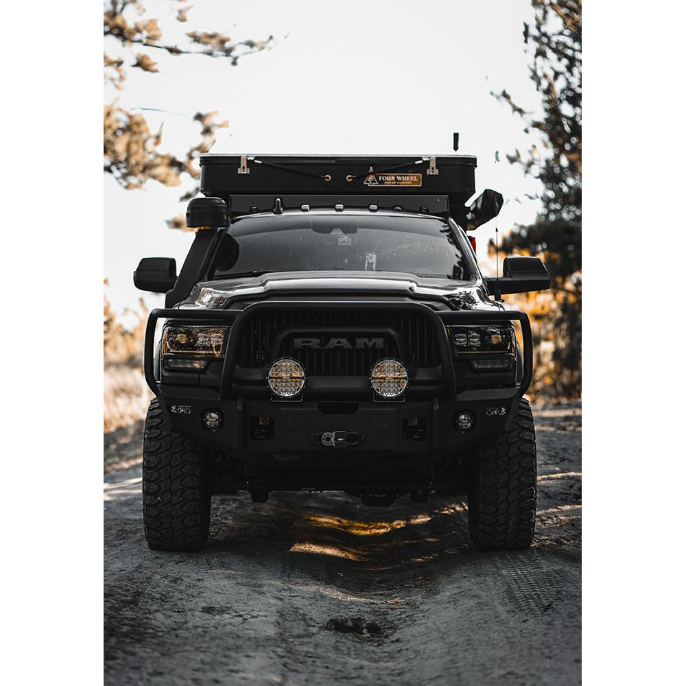 Black Ram truck with roof rack and off-road lights, ready for adventure