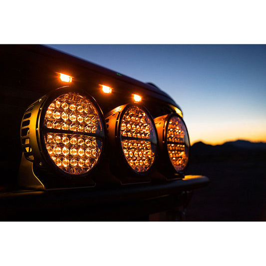 Bright amber LED off-road lights mounted on vehicle at dusk, ideal for auto styling and night driving.