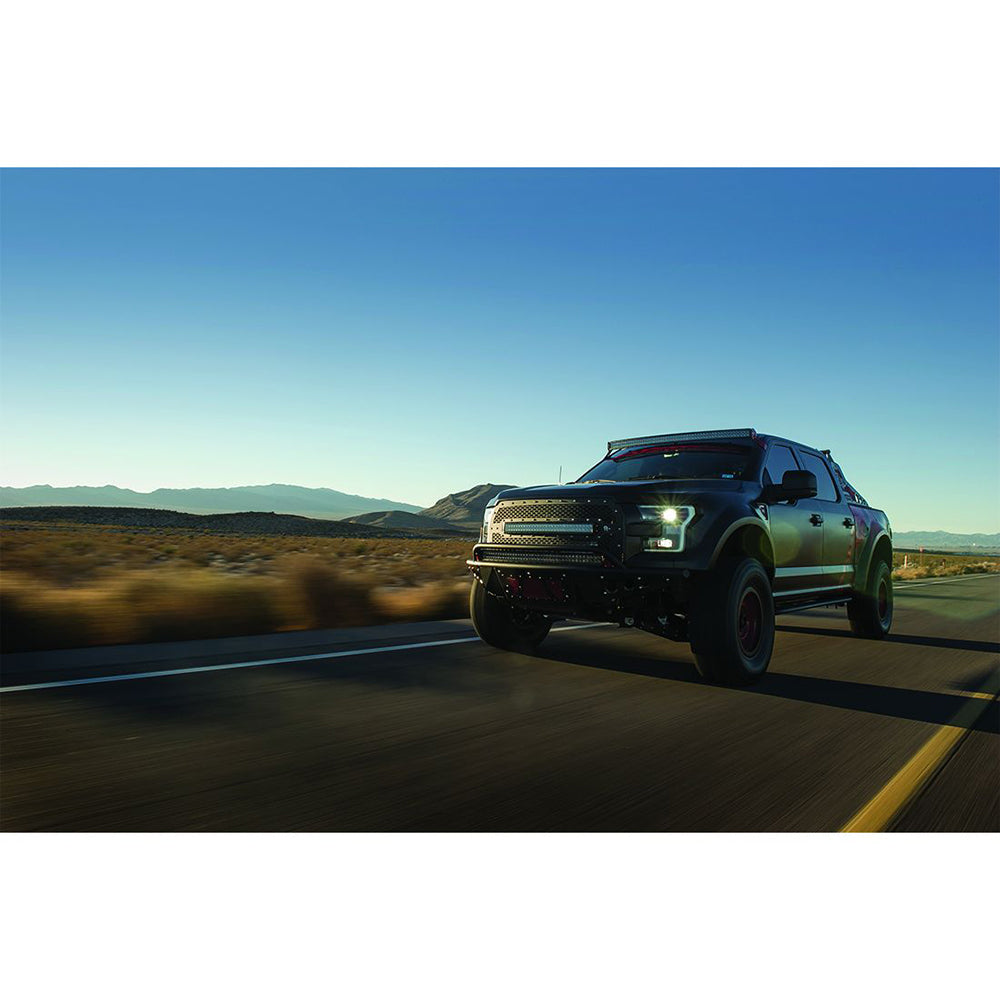 Black off-road truck with LED lights cruising desert highway, showcasing custom auto styling and performance upgrades.