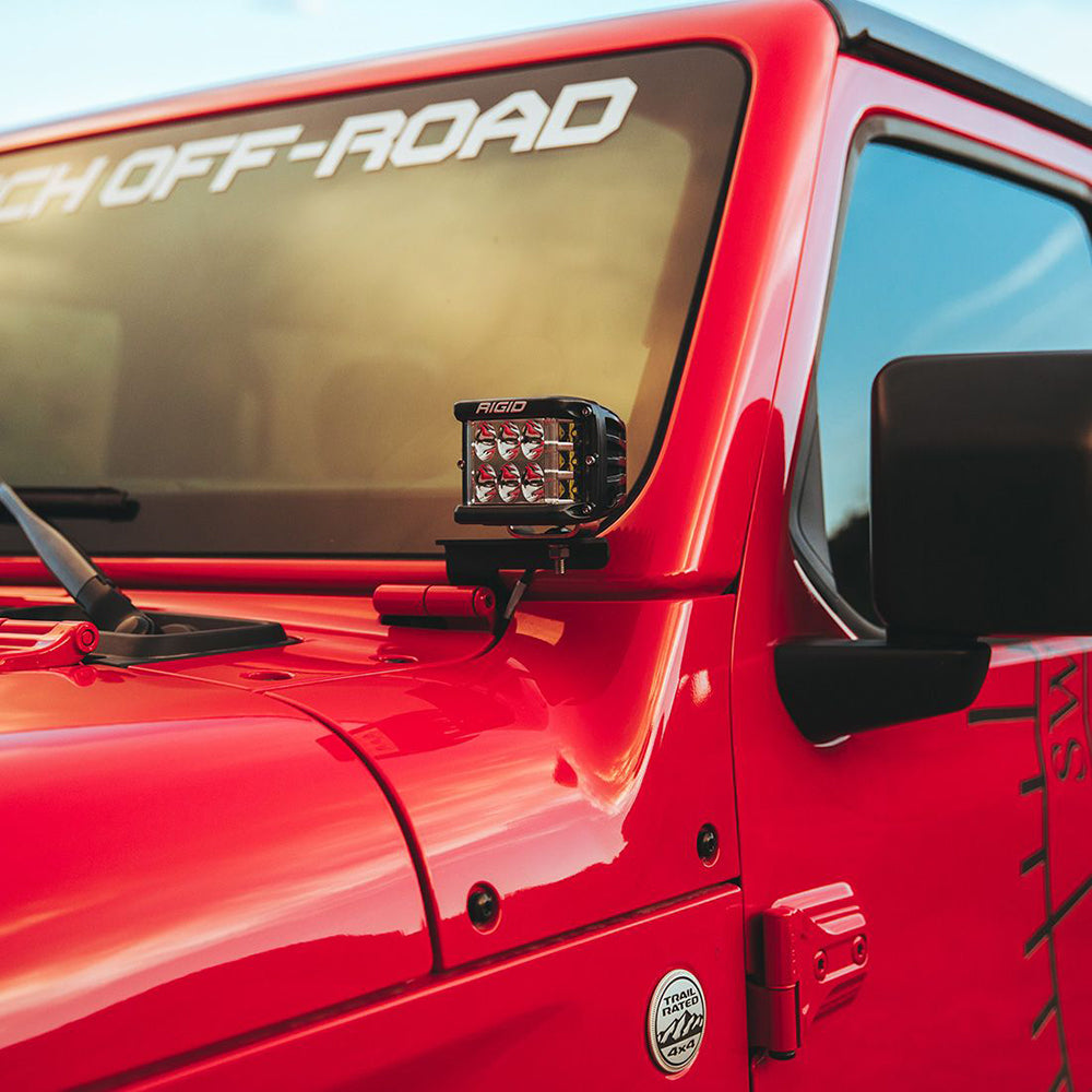 Red Jeep with Rigid LED light bar, off-road decals, and 4x4 badge for rugged trail use