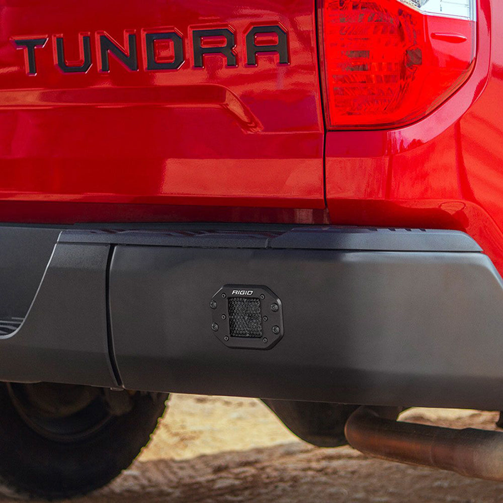Rigid LED light mounted on rear bumper of red Toyota Tundra truck