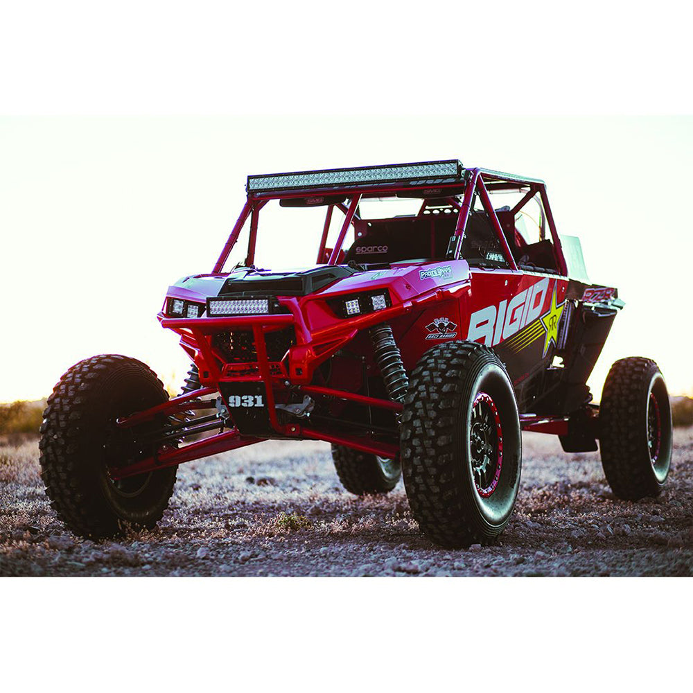 Red Rigid UTV with LED lights and off-road tires on rugged terrain