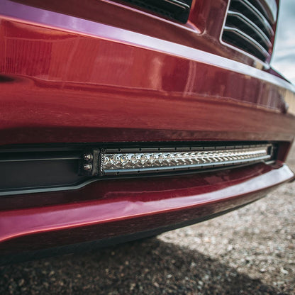 Rigid LED light bar installed on red truck bumper for off-road illumination
