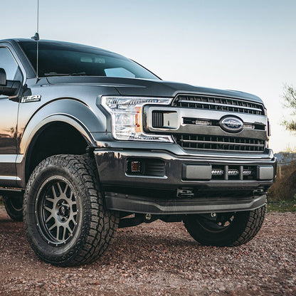 Custom Ford F-150 with off-road tires and LED lighting, showcasing premium auto styling and rugged upgrades.