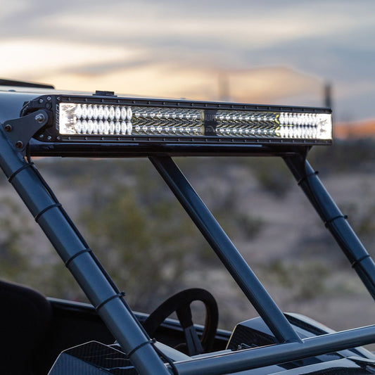 Bright LED light bar mounted on off-road vehicle roll cage for desert driving illumination