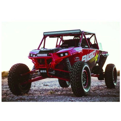 Red off-road UTV with LED lights and rugged tires on dirt terrain